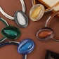 Colorful oval brooches on a brown background