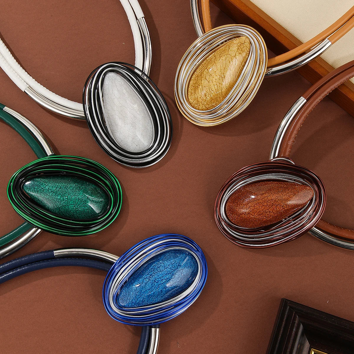 Collection of Colorful oval brooches on a brown background