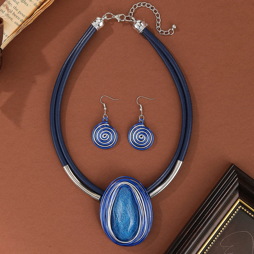 Jewelry set with blue and silver necklace and earrings on a brown background