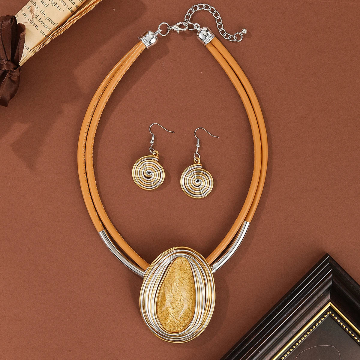 Jewelry set with necklace and earrings on a brown background