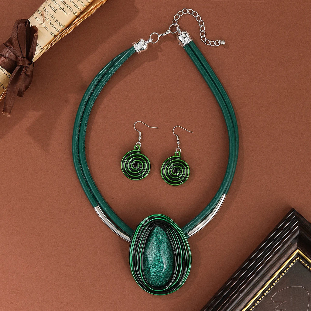 Green necklace and earrings set on a brown surface