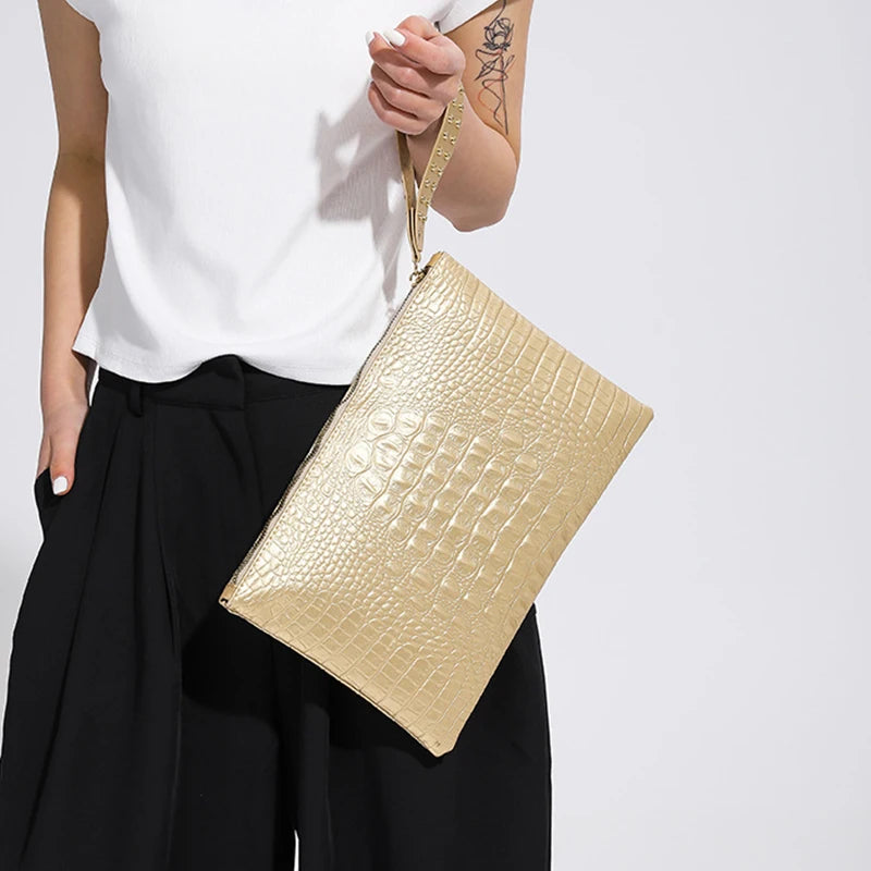 Model holding gold Fashion Luxury Clutch 