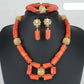 Jewelry set with red coral beads and gold accents on a mannequin. Fashion Nigerian Coral Beads Set