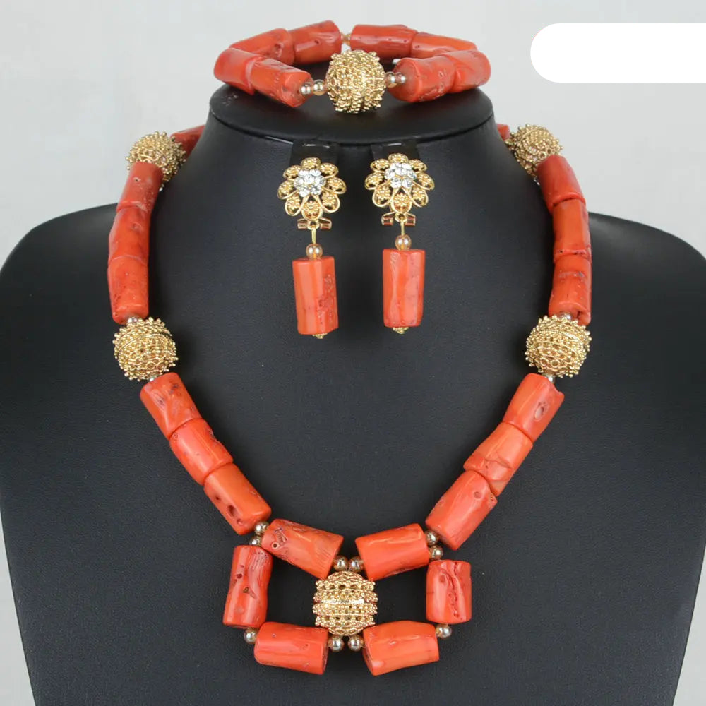 Jewelry set with red coral beads and gold accents on a mannequin. Fashion Nigerian Coral Beads Set