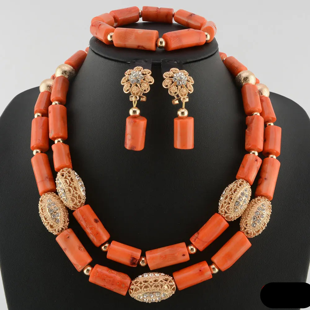 Coral-colored necklace and earrings set on a black mannequin with 'C016' label. Fashion Nigerian Coral Beads Set
