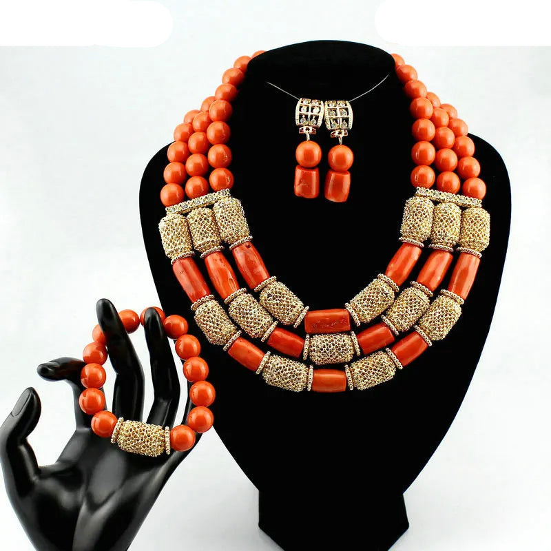 Jewelry set with orange beads and gold accents on a black mannequin hand and stand, Fashion Nigerian Coral Beads Set