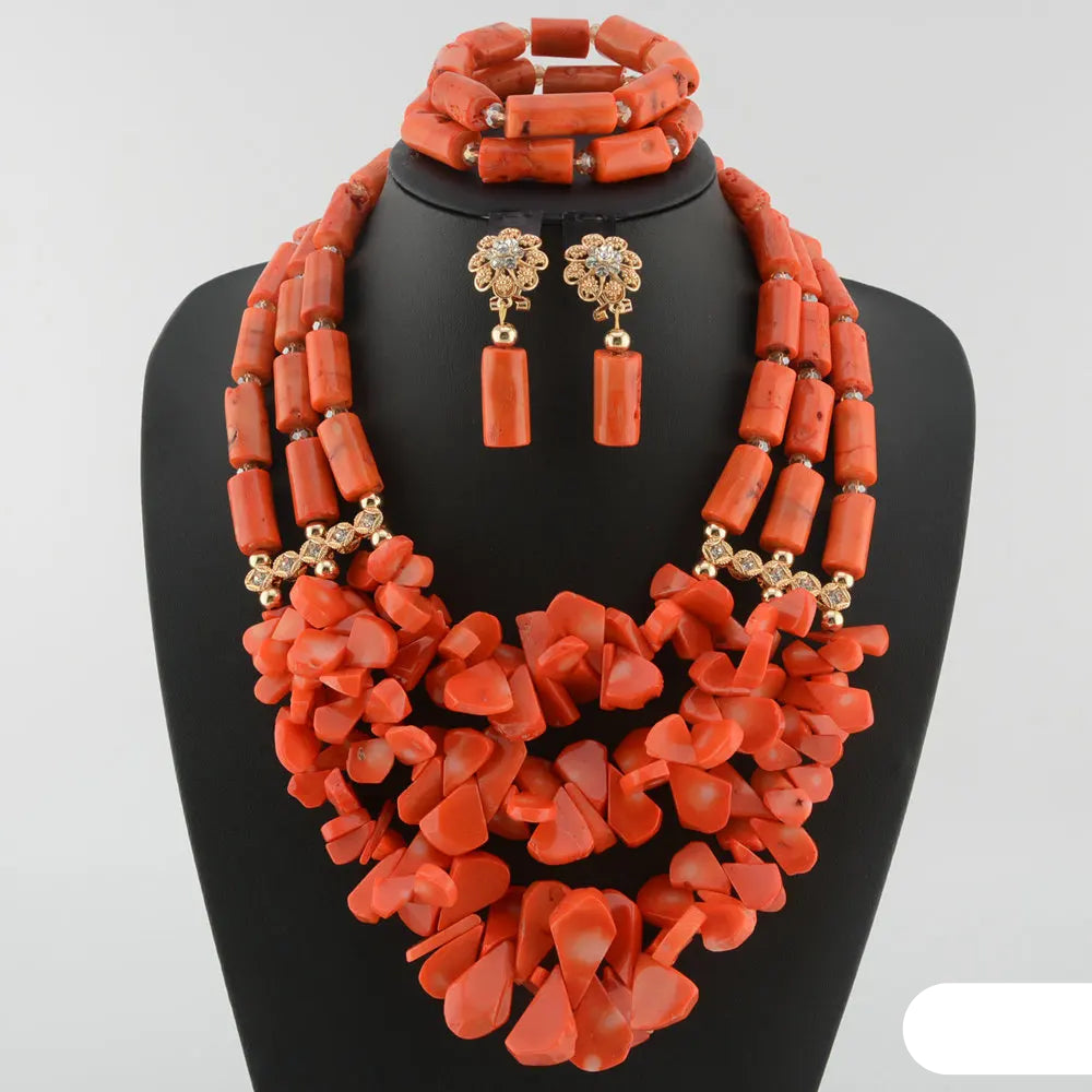 Coral-colored jewelry set including necklace, earrings, and bracelet on a black stand. Fashion Nigerian Coral Beads Set