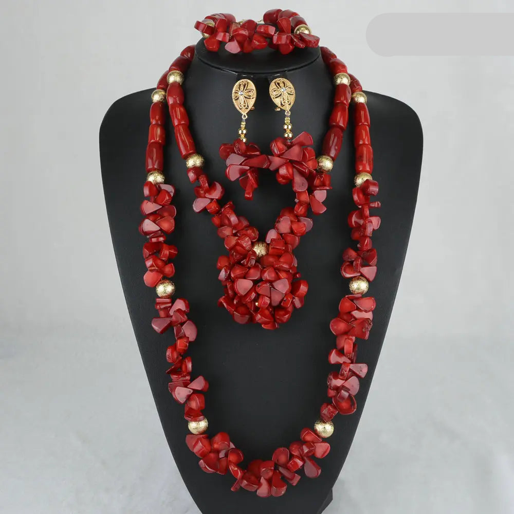Red jewelry set with gold accents on a black mannequin against a gray background.