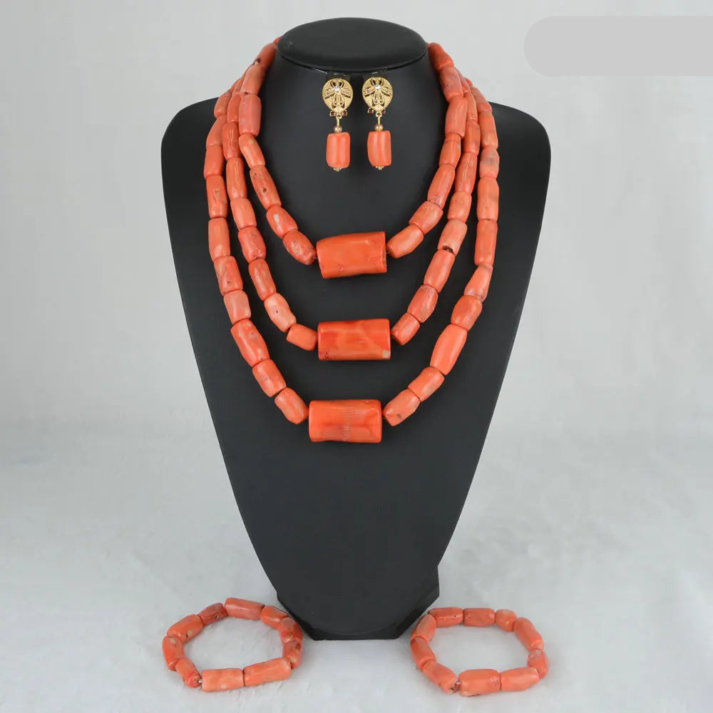 Coral-colored jewelry set on a black mannequin with 'C007-2' label.