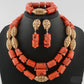 Coral jewelry set with gold accents on a black mannequin