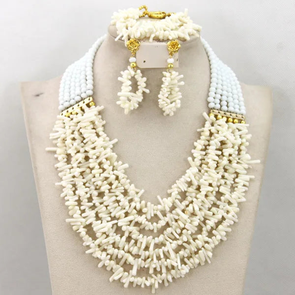 White beaded necklace, earrings, and bracelet set on a mannequin bust.