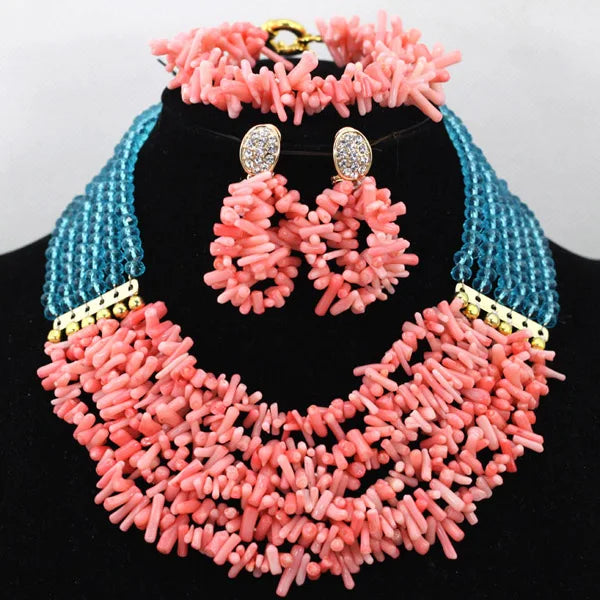 Necklace and earrings set with pink and blue beads on a black stand.