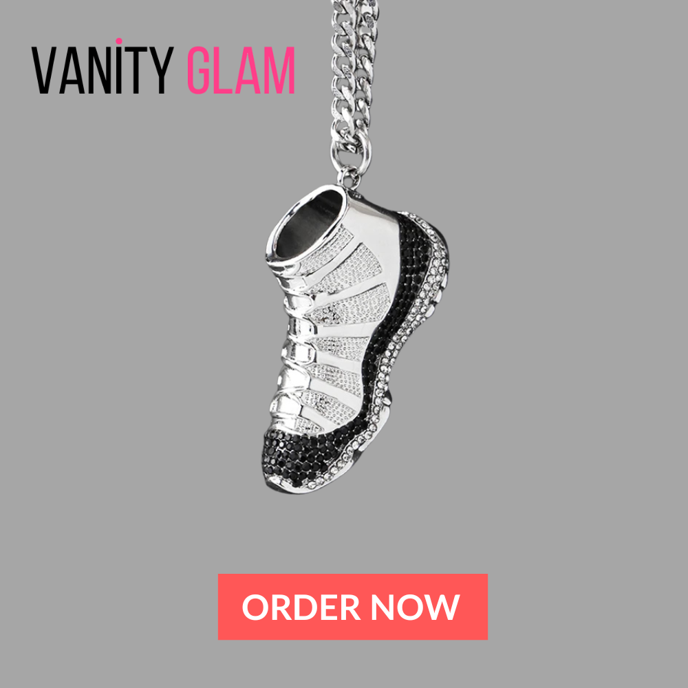 Silver shoe-shaped pendant necklace on a gray background with 'Vanity Glam' branding.