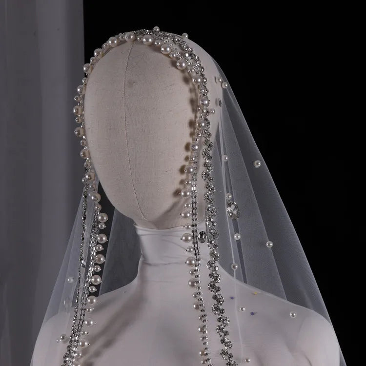 Vintage ivory bridal veil with pearls and rhinestones, elegant wedding headdress for bride.