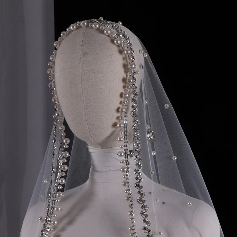 Vintage ivory bridal veil with pearls and rhinestones, elegant wedding headdress for bride.